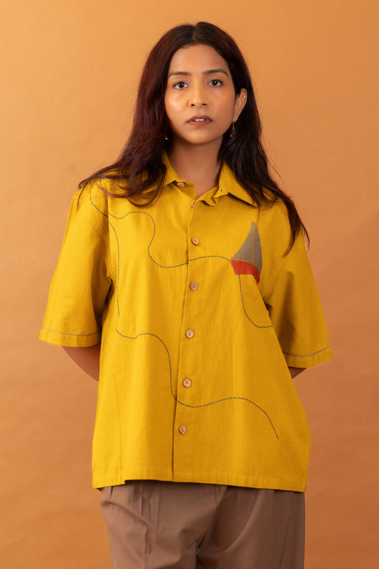 Woman wearing a yellow shirt with a brown background