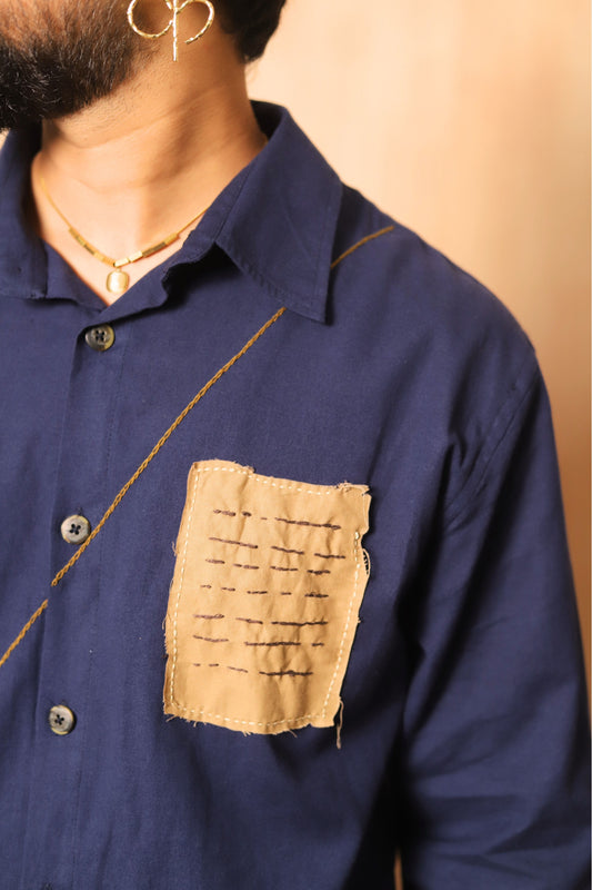Navy blue shirt with a patch on a beige background